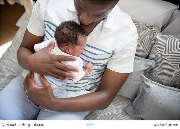 Parent holding a newborn baby
